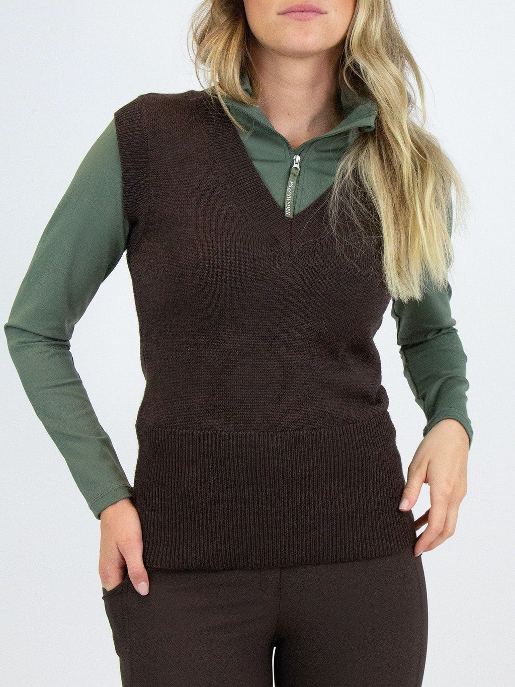 Mid-gauge knit vest made in responsibly produced merino wool blend. Rib-knitted tall collar with placket of large horn imitation buttons. 