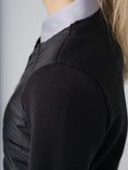 Load image into Gallery viewer, Jacket with a padded front and full logo button closing. Back and sleeves are made in a warm, tight knitted merino blend. Detailed with a rounded, scooped neck and two welt pockets at front.
