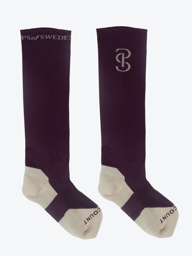 High performance knee-high riding socks in a soft compression pique stitch. Padded comfortable toe and heel reinforcements, with a fine rib in between, and mesh insert at mid-foot. 